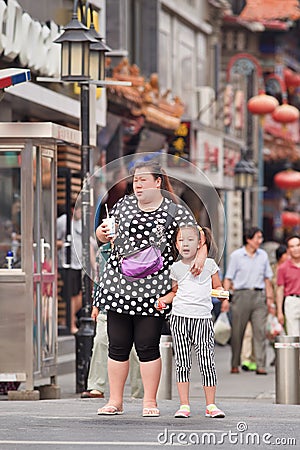 Overweight woman with child, Beijing, China Editorial Stock Photo